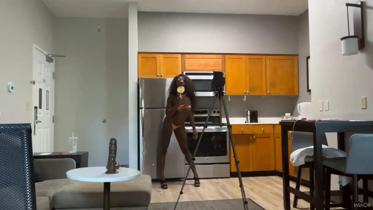 Lola Black teases in stripper heels and plays with her nipple-pierced lollipop