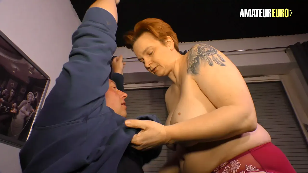 Big tit redhead swallows his cock while stripping on couch
