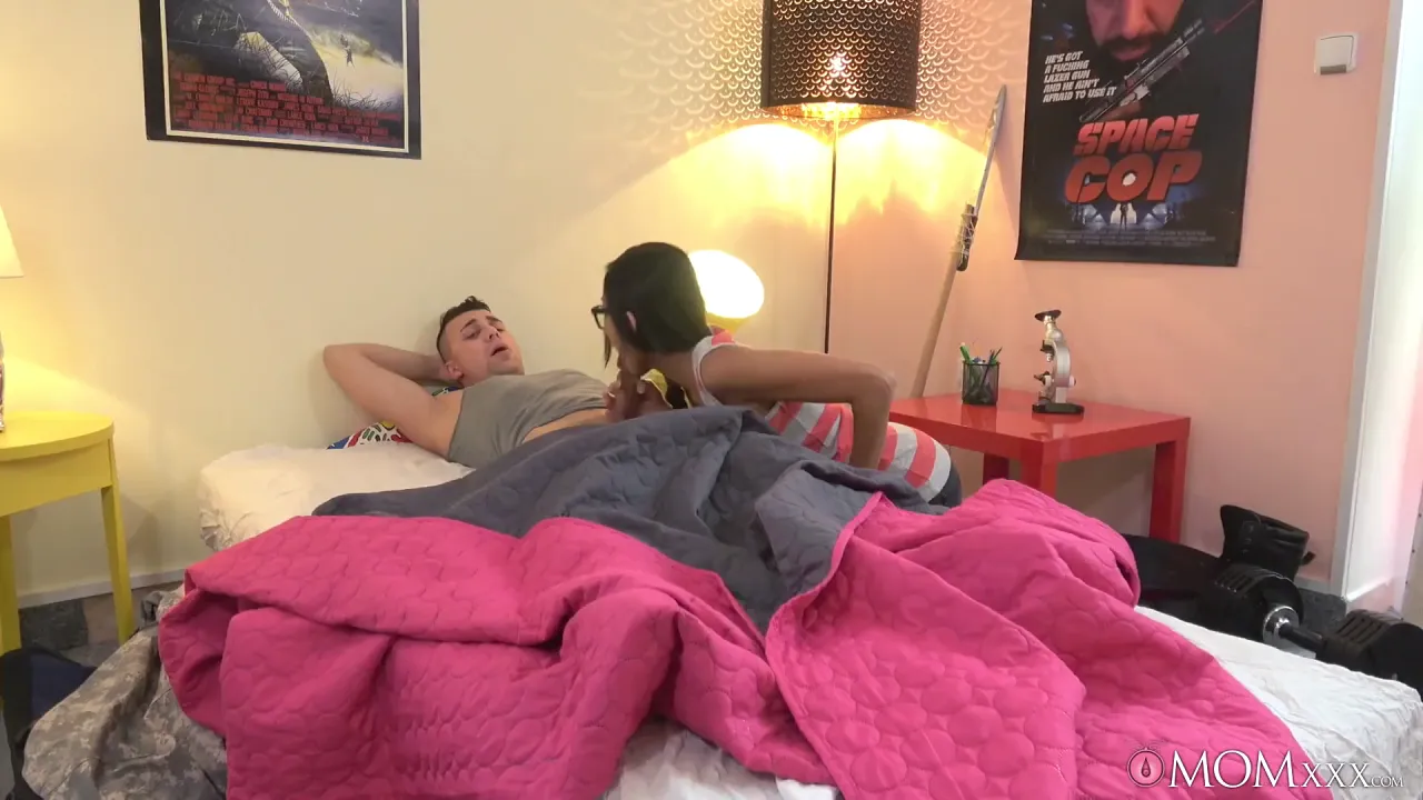 Asian MILF with glasses seduces her stepson and fucks him in bed