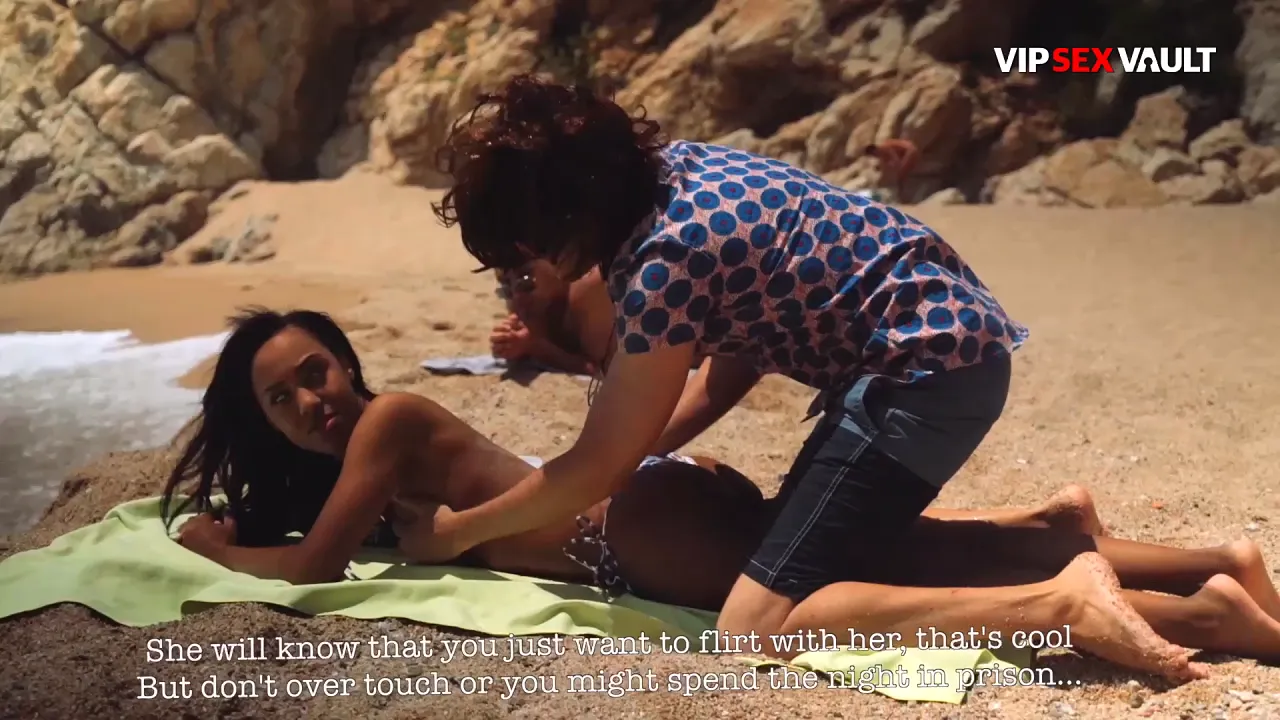 Ebony babe gets her bare back massaged and ass stroked by a fetish model on the beach