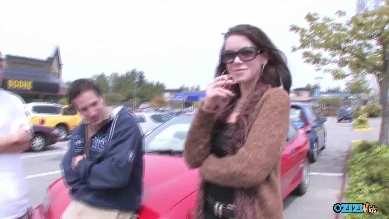 Slutty MILF seduces two guys for a threesome orgy in the parking lot
