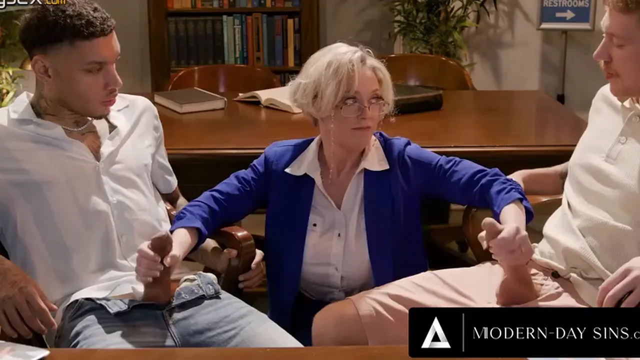 Mature teacher Dee Williams jerks off two students before getting double penetrated in a