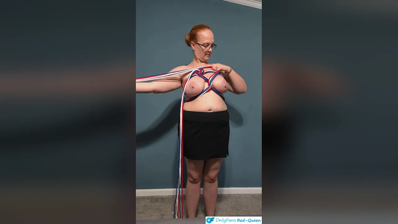 Red-haired MILF Red Queen ties herself into a heart shape for the 4th of July